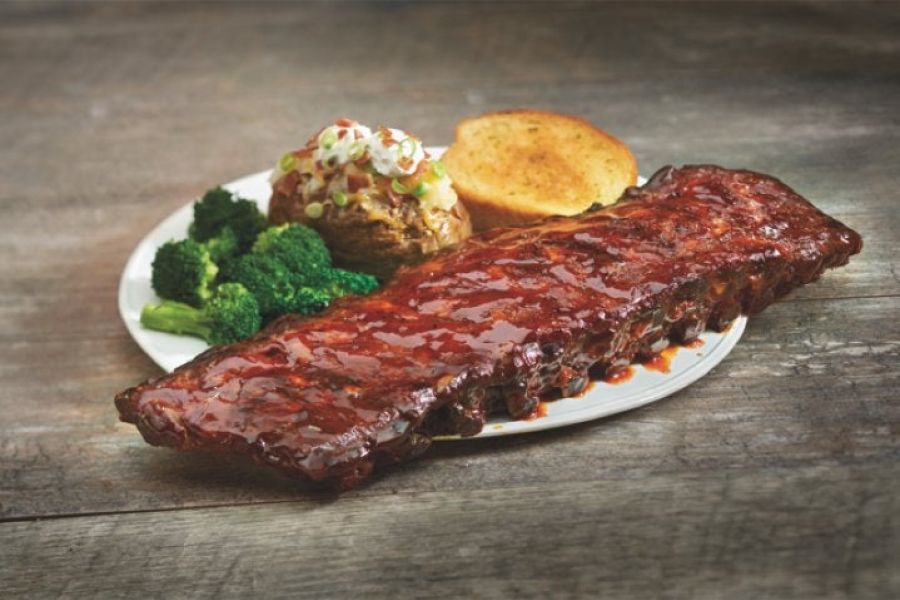 The Amber at Greenbrier A plate of glazed ribs with broccoli, baked potato topped with sour cream, and a slice of toasted bread.