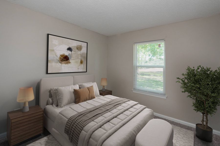 A cozy bedroom with a bed, nightstands, lamps, wall art, and a window with sunlight coming in.